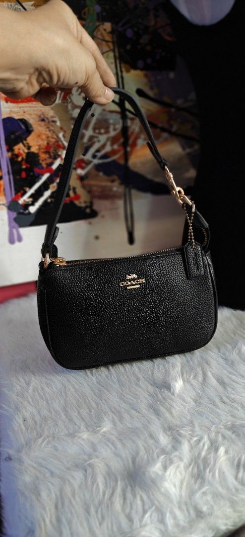 Coach Black Pebble Leather Mini Bag (Category: Luxury Bags & Wallets) located in Las Pinas. Submitted by liezel49 (Listing ID 1469424027, Image 1). Description: - Brand: Coach - Material: Premium black pebble leather - Hardware: Elegant gold-tone with front gold foil logo stamp - Closure: Secure top zipper - Inclusion: Matching hangtag - Strap: Short detachable shoulder strap with lobster clasps - Condition: Excellent, clean interior and stitchin