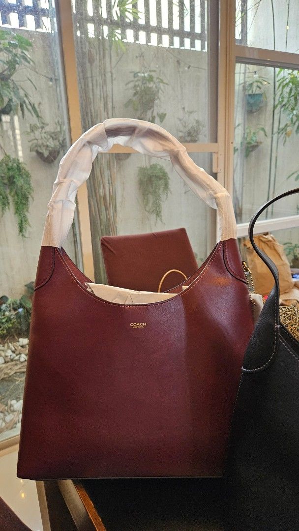 Coach Brooklyn (Category: Luxury Bags & Wallets) located in Rizal. Submitted by vanbdc24 (Listing ID 1469506100, Image 3). Description: - Brand: Coach - Styles: Leather shoulder bags with clean silhouettes and subtle Coach New York branding size 28, 34 and 39 - Colors available: Black, Dark Brown, and Burgundy - Hardware: Premium gold-tone hardware - Condition: Brand new, handles wrapped in protective packaging (one black bag styled with a bonus 