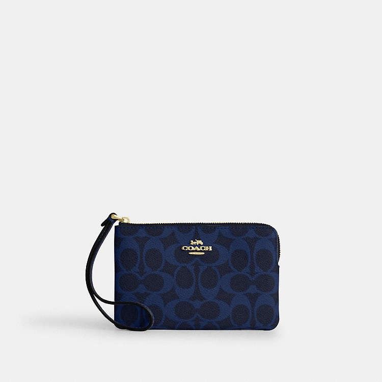 Coach Corner Zip Wristlet (Category: Wallets & Card holders) located in Las Pinas. Submitted by shopwithmira13 (Listing ID 1469509956, Image 3). Description: - 100% Authentic Coach wristlet - Secure zip-top closure with attached wrist strap - Features the classic Coach horse and carriage logo - Compact and handy size for cards, cash, and keys - Available finishes: Black metallic leather, denim signature jacquard, blue signature pattern, and burgu