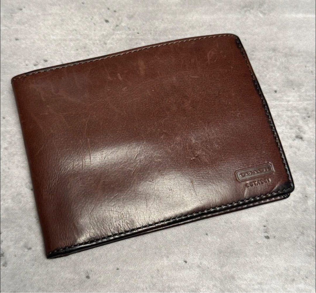 Coach Est. 1941 Brown Leather Bifold Wallet (Category: Luxury Bags & Wallets) located in Baguio. Submitted by gokubusansan (Listing ID 1469560075, Image 1). Description: - Authentic Coach bifold wallet in rich brown leather - Features debossed Coach logo and Est. 1941 stamp on the front corner - Multiple card slots on both sides and a spacious main bill compartment - Genuine leather construction with natural wear patterns and unique character - C
