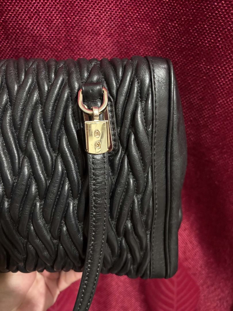Coach Madison Quilted Leather (Category: Luxury Bags & Wallets) located in Caloocan City. Submitted by classicurations (Listing ID 1469485467, Image 3). Description: Coach Black leather shoulder bag with distinct quilted weave texture across the body. Gold-tone hardware accents the strap attachments and zipper. Dual top handles for carrying. Zip closure runs along the top. Clean stitching throughout. (No Hangtag) .