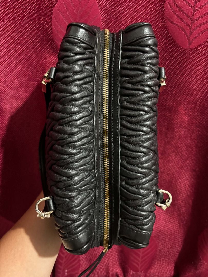 Coach Madison Quilted Leather (Category: Luxury Bags & Wallets) located in Caloocan City. Submitted by classicurations (Listing ID 1469485467, Image 2). Description: Coach Black leather shoulder bag with distinct quilted weave texture across the body. Gold-tone hardware accents the strap attachments and zipper. Dual top handles for carrying. Zip closure runs along the top. Clean stitching throughout. (No Hangtag) .