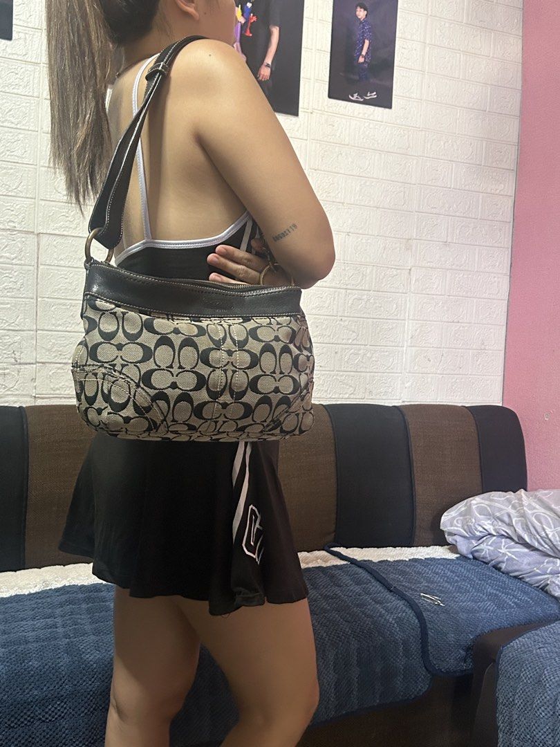 Coach Signature C Monogram Hobo Shoulder Bag (Category: Luxury Bags & Wallets) located in San Jose del Monte. Submitted by jenflores33996 (Listing ID 1469406076, Image 3). Description: - Authentic Coach signature C monogram shoulder bag - Black and beige canvas body with dark leather trim and strap - Secure zipper top closure - Stylish brass tone hardware rings on the sides - Comfortable drop length for shoulder or underarm carry.