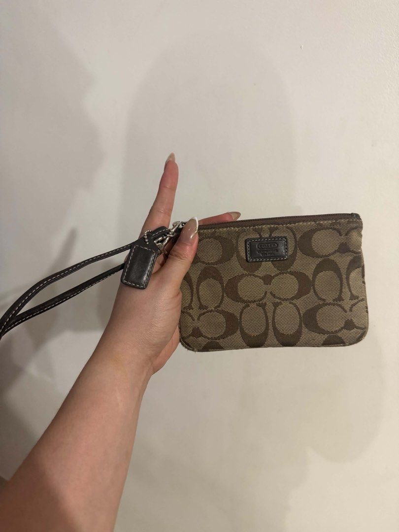 Coach Signature C Wristlet Brown (Category: Luxury Bags & Wallets) located in Bocaue. Submitted by nhaomiee (Listing ID 1469459061, Image 3). Description: - Authentic Coach signature C pattern on brown fabric - Dark brown leather trim and wrist strap with stylish white contrast stitching - Secure silver-tone zipper closure - Includes classic leather hangtag and front Coach logo patch - Compact and handy size, ideal for cards and cash.