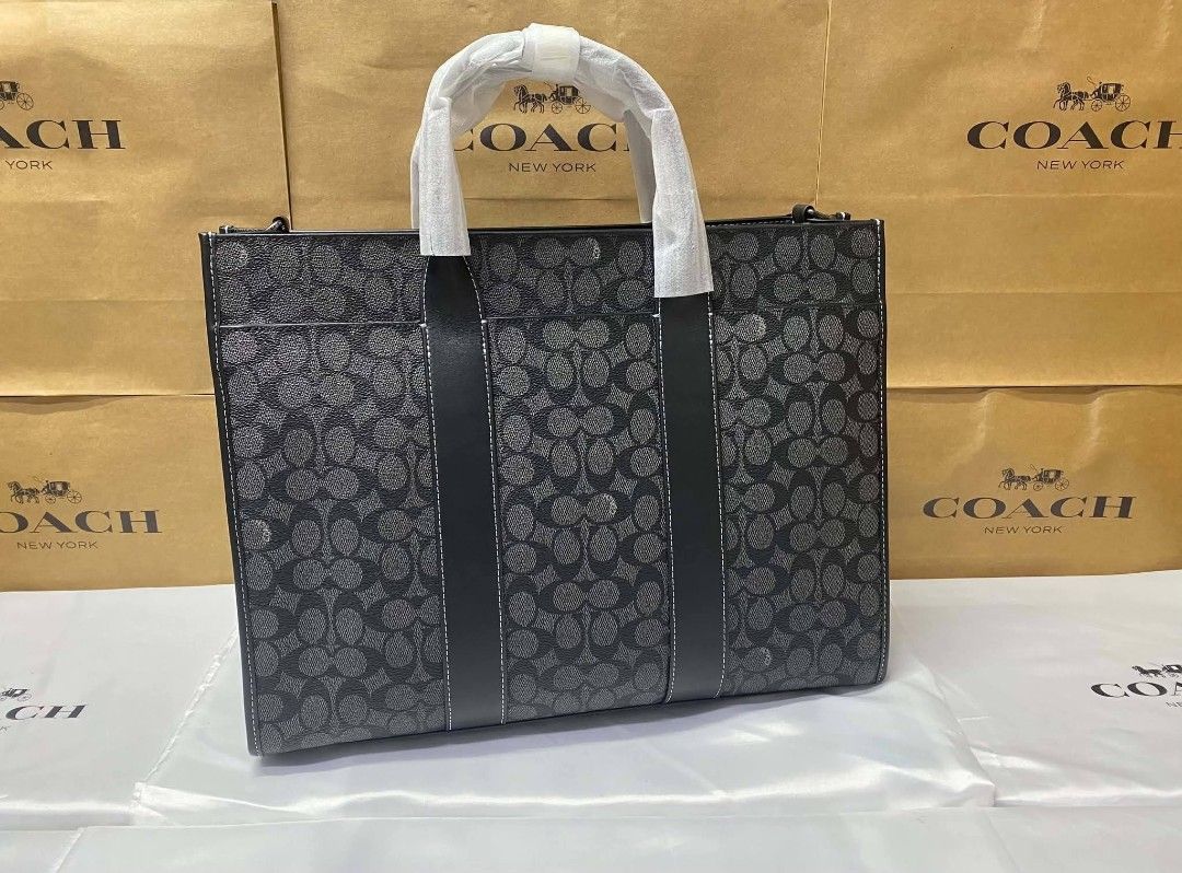 Coach Signature Monogram Tote Bag Black (Category: Luxury Bags & Wallets) located in Rizal. Submitted by vanbdc24 (Listing ID 1469509026, Image 2). Description: - Brand: Coach - Color: Black Signature Monogram Canvas - Condition: Brand New with protective wrapping on handles - Features: Secure zip top closure, spacious interior lining, interior zip and slip pockets - Versatility: Includes a detachable crossbody strap and classic hangtag - Perfect