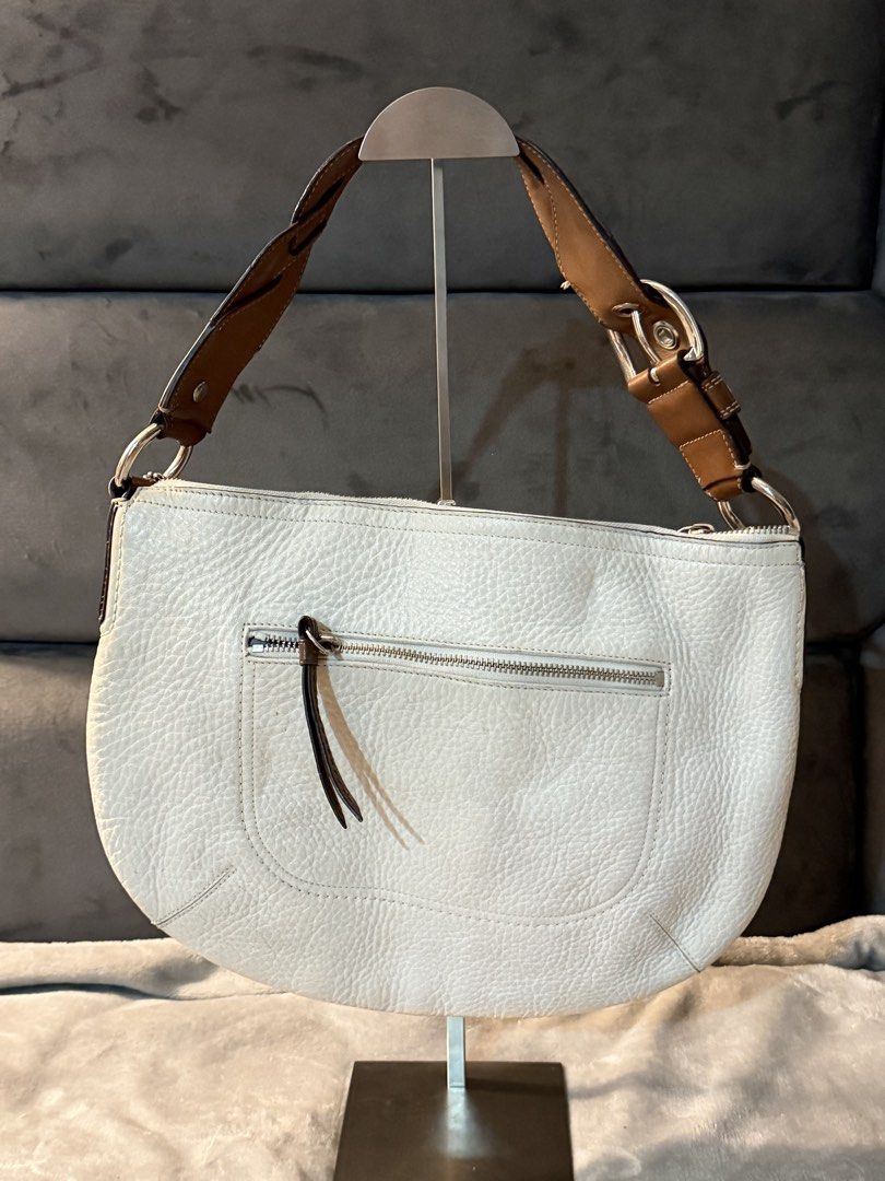 Coach Soho Pleated Pebbled Leather Braided Handle Hobo (Category: Luxury Bags & Wallets) located in Pavia. Submitted by c4rrye (Listing ID 1469544711, Image 2). Description: RANK AB (8.5/10) discoloration/wear on the hangtag subtle wear along the braided strap edge clean interior red cherry charm is displayed for styling only and is not included..