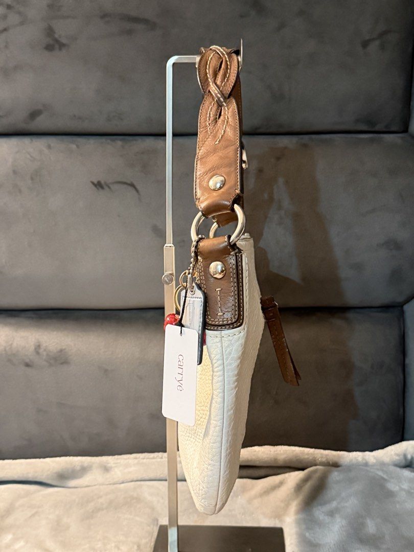 Coach Soho Pleated Pebbled Leather Braided Handle Hobo (Category: Luxury Bags & Wallets) located in Pavia. Submitted by c4rrye (Listing ID 1469544711, Image 3). Description: RANK AB (8.5/10) discoloration/wear on the hangtag subtle wear along the braided strap edge clean interior red cherry charm is displayed for styling only and is not included..