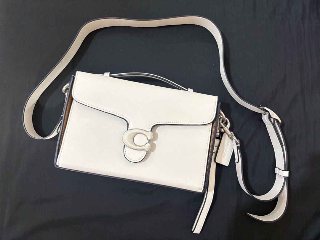 Coach Tabby Messenger White Leather Shoulder Bag (Category: Luxury Bags & Wallets) located in Cainta. Submitted by tokadore (Listing ID 1469394597, Image 2). Description: - Coach Tabby messenger bag in crisp white glovetanned leather - Features polished silver hardware and the iconic C clasp front closure - Luxurious brown suede interior lining - Versatile design includes a detachable top handle and adjustable shoulder strap - Comes with the orig