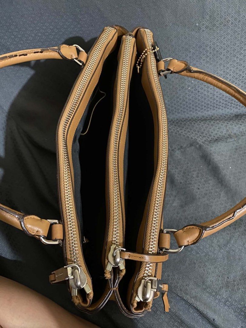 Coach Tan Leather Handbag (Category: Luxury Bags & Wallets) located in Manila. Submitted by melissatua68314 (Listing ID 1469517866, Image 3). Description: - Coach tan leather handbag - Dual top handles with secure zip top closure - Spacious interior lined with black fabric - Multiple zipped inner compartments for easy organization - Silver-tone hardware and signature black Coach hangtag - Coach creed patch stamped inside (Style # L1393-30348) - S