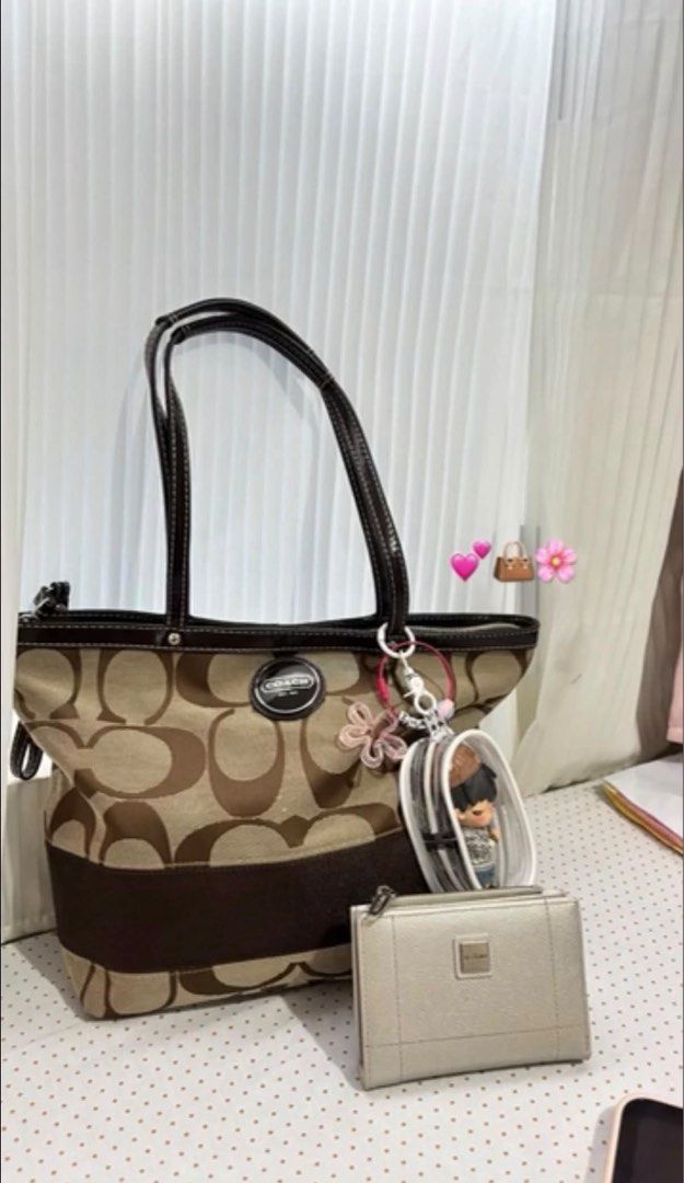 Coach Tote Bag Brown Tan (Category: Luxury Bags & Wallets) located in Angeles City. Submitted by chayy_ (Listing ID 1469470809, Image 2). Description: - Authentic Coach signature C print tote bag - Classic brown and tan canvas with dark brown leather handles and trim - Secure top zip closure for everyday essentials - Includes signature leather hangtag and front circular Coach logo medallion - Spacious interior, perfect for work or daily use - Con