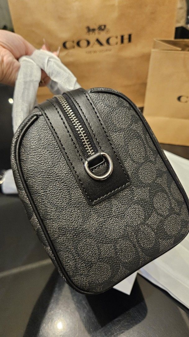 Coach Venturer (Category: Luxury Bags & Wallets) located in Rizal. Submitted by vanbdc24 (Listing ID 1469505301, Image 3). Description: - Authentic Coach Boston Bag in charcoal signature canvas - Black leather trim, dual top zip closure, and detachable shoulder strap - Features stylish yellow chenille letter C and red varsity shield patches with round Coach logo - Includes original dust bag and paper bag - Meet-ups and same-day delivery available