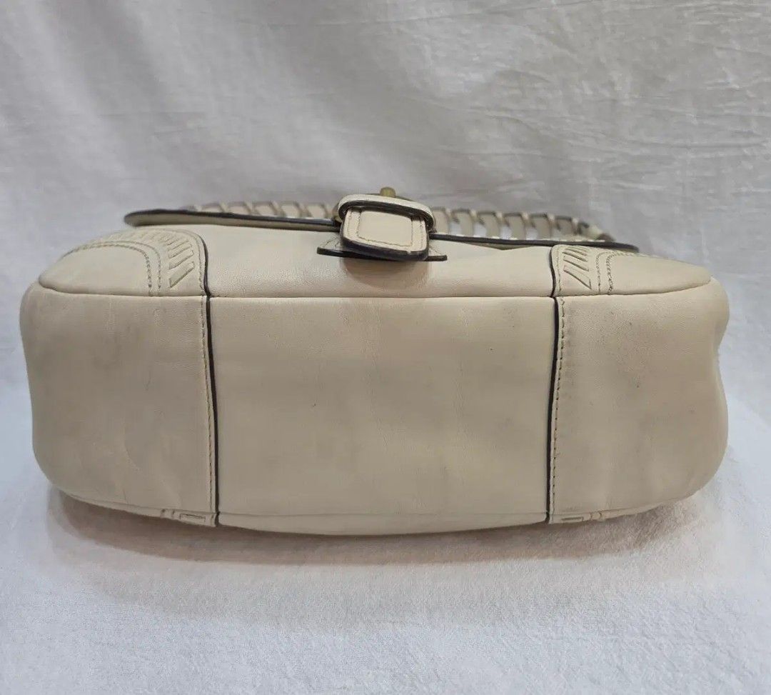Coach White Leather Shoulder Bag Braided Strap (Category: Shoulder Bags) located in Manila. Submitted by preloved439 (Listing ID 1469419806, Image 3). Description: Authentic Coach white leather shoulder bag with a braided strap and brass hardware. Front flap closure with a buckle accent and decorative stitching along the edges. Back slip pocket included. Hangtag attached to the side ring. Clean neutral shade that matches many outfits. Regular wea