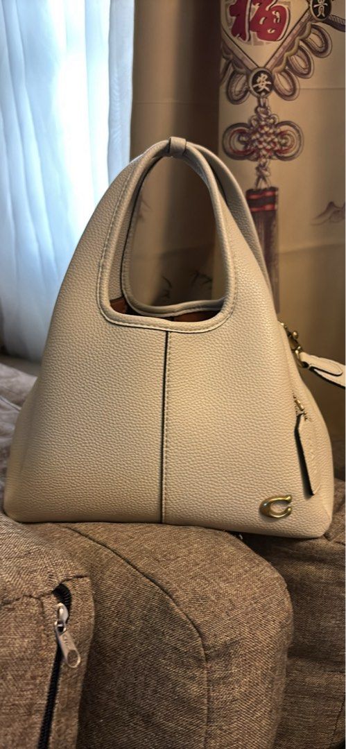 Coach White Leather Tote Shoulder Bag with Strap (Category: Luxury Bags & Wallets) located in Imus. Submitted by charliexcx44 (Listing ID 1469477579, Image 1). Description: - Brand: Coach - Material: Genuine pebbled leather - Color: Off-white with gold-tone hardware and signature 'C' logo tag - Straps: Double top handles and an adjustable, detachable shoulder strap - Interior: Tan lining with Coach creed patch - Condition/Style: Roomy daily carry
