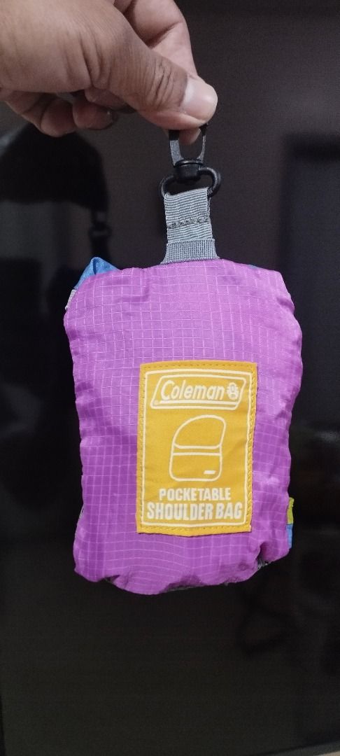 Coleman Pocketable Shoulder Bag (Category: Shoulder Bags) located in Koronadal. Submitted by jrdar (Listing ID 1469572076, Image 1). Description: - Brand: Coleman - Color: Vibrant multi-color (purple, blue, lime green) with grey strap - Material: Lightweight, durable ripstop nylon - Design: Folds compactly into its own attached pouch with a convenient clip hook - Usage: Ideal for travel, hiking, gym, or quick grocery runs.