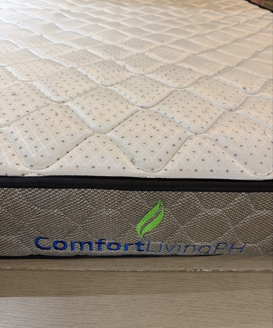 ComfortLivingPH Mattress (Category: Bed Frames & Mattresses) located in Taguig. Submitted by martinvlee (Listing ID 1469408830, Image 1). Description: - Brand: ComfortLivingPH - Design: Elegant quilted diamond pattern top with subtle grey detailing - Aesthetics: Premium brown textured fabric border with stitched brand logo - Structure: Standard rectangular shape with solid, supportive edges - Condition: Clean upper surface, well-maintained - Fulf
