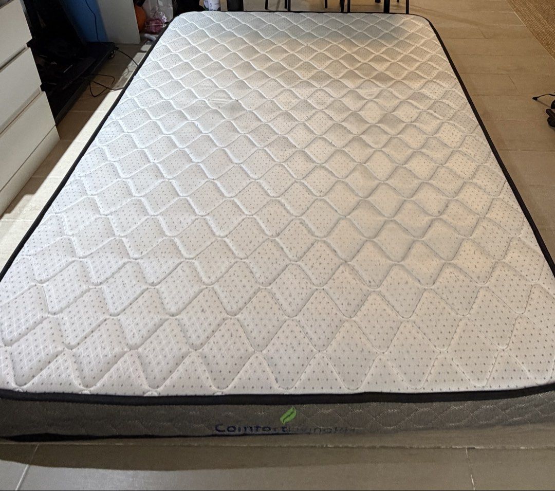 ComfortLivingPH Mattress (Category: Bed Frames & Mattresses) located in Taguig. Submitted by martinvlee (Listing ID 1469408830, Image 3). Description: - Brand: ComfortLivingPH - Design: Elegant quilted diamond pattern top with subtle grey detailing - Aesthetics: Premium brown textured fabric border with stitched brand logo - Structure: Standard rectangular shape with solid, supportive edges - Condition: Clean upper surface, well-maintained - Fulf
