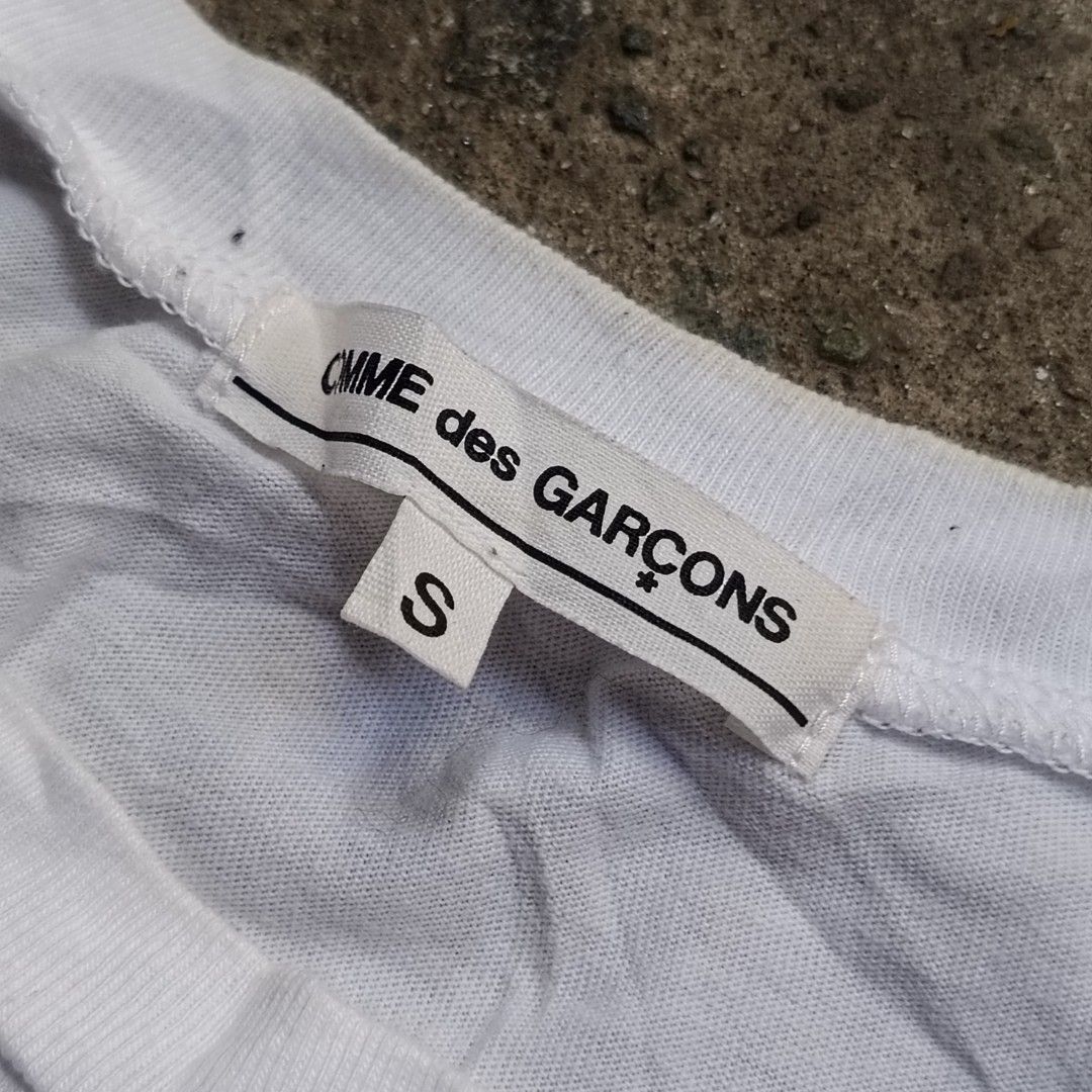 COMME des GARÇONS Thinking and Doing T-Shirt Size S (Category: Shirts) located in Caloocan City. Submitted by gemfinder669 (Listing ID 1469457437, Image 2). Description: - Brand: Authentic COMME des GARÇONS - Collection: AD2020 - Color: White with bold black typography and red 'FUTURE' lettering - Material: 100% Cotton - Size: Small - Fit: Regular crew neck, short sleeves - Origin: Made in Japan - Condition: Excellent, cool statement piece.