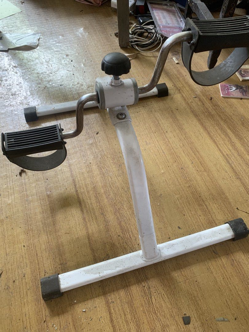 Compact Pedal Exerciser for Arms and Legs (Category: Cardio & Fitness Machines) located in Quezon City. Submitted by sojisup (Listing ID 1469396689, Image 3). Description: - Sturdy white steel frame with secure rubber feet - Textured black foot pedals with adjustable straps - Built-in tension knob for customizable resistance - Compact and portable design fits easily under desks or in front of chairs - Ideal for light daily fitness and physical re