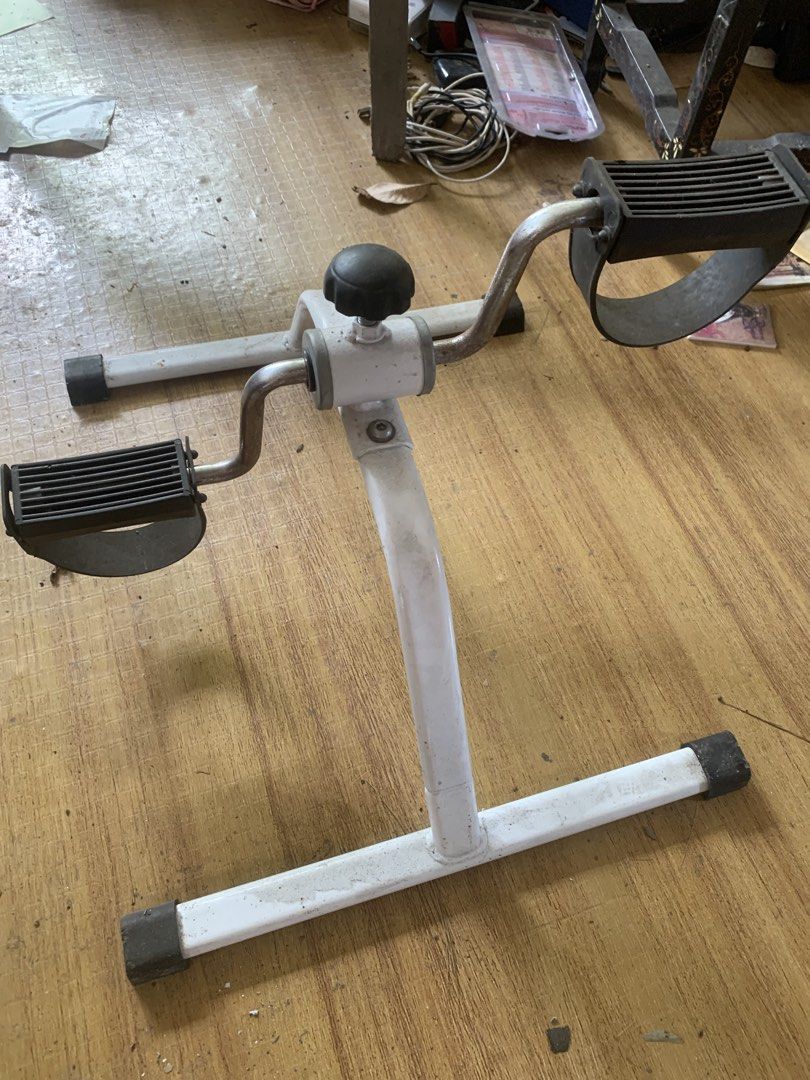 Compact Pedal Exerciser for Arms and Legs (Category: Cardio & Fitness Machines) located in Quezon City. Submitted by sojisup (Listing ID 1469396689, Image 1). Description: - Sturdy white steel frame with secure rubber feet - Textured black foot pedals with adjustable straps - Built-in tension knob for customizable resistance - Compact and portable design fits easily under desks or in front of chairs - Ideal for light daily fitness and physical re