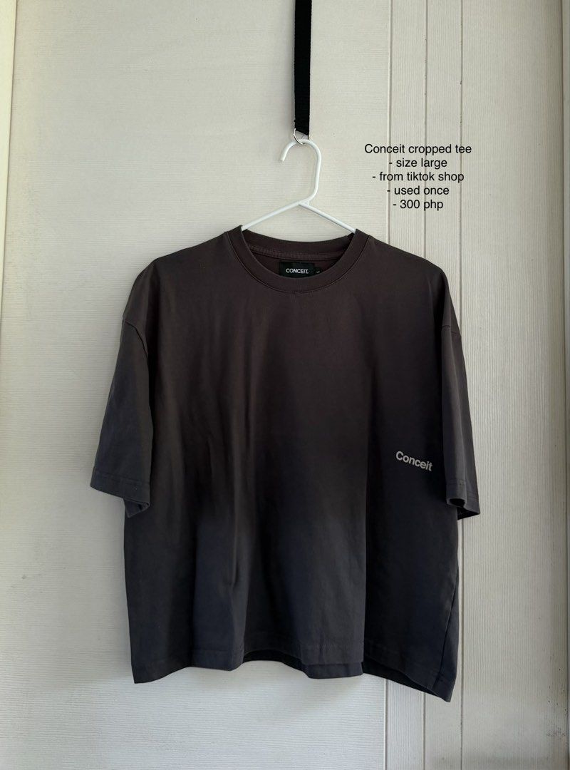 Conceit Cropped Tee Size Large (Category: Tshirts & Polo Shirts ) located in Manila. Submitted by cinnmoroll (Listing ID 1469402075, Image 1). Description: - unisex Brand: Conceit - Style: Cropped tee with relaxed fit - Color: Dark Grey - Size: Large - Design: Small chest text, large bold CONCEIT back print - Condition: Worn once, practically brand new with no flaws or fading.