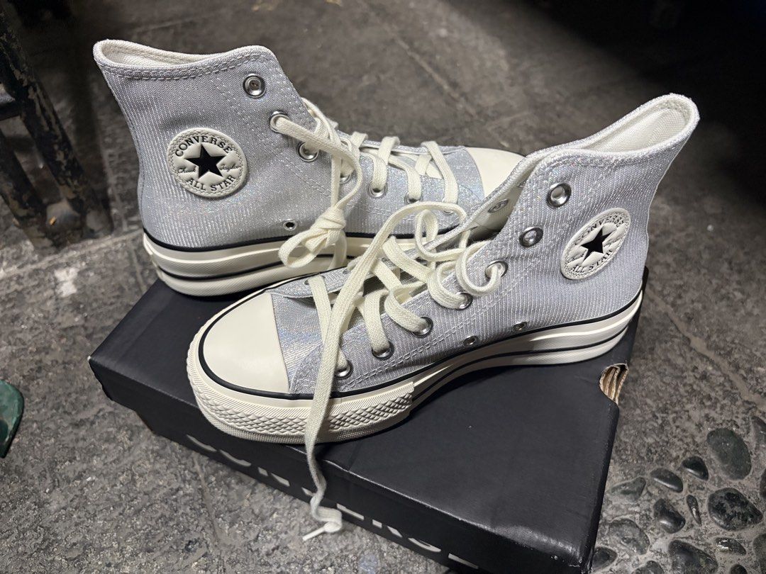 Converse Chuck Taylor All Star Platform High Top (Category: Sneakers) located in Manila. Submitted by lily_rye (Listing ID 1469494684, Image 1). Description: - Brand: Converse - Style: High top sneakers with platform sole - Color: Silver glitter with cream laces - Features: Classic rubber toe cap - Inclusion: Original black Converse shoebox - Condition: Well-maintained and ready to wear.