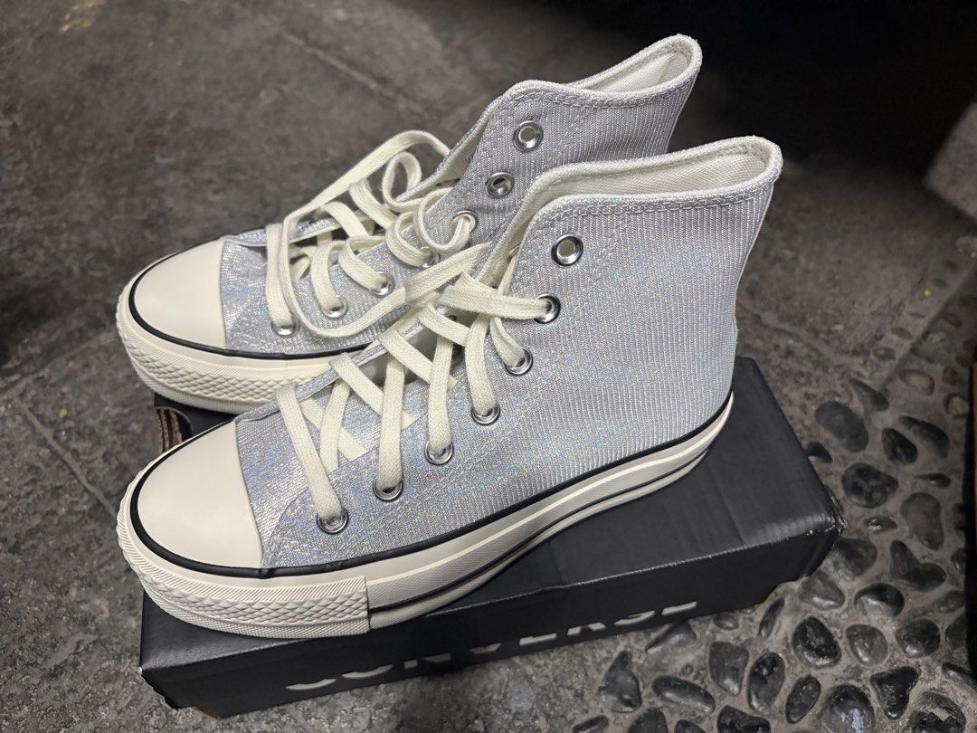 Converse Chuck Taylor All Star Platform High Top (Category: Sneakers) located in Manila. Submitted by lily_rye (Listing ID 1469494684, Image 2). Description: - Brand: Converse - Style: High top sneakers with platform sole - Color: Silver glitter with cream laces - Features: Classic rubber toe cap - Inclusion: Original black Converse shoebox - Condition: Well-maintained and ready to wear.