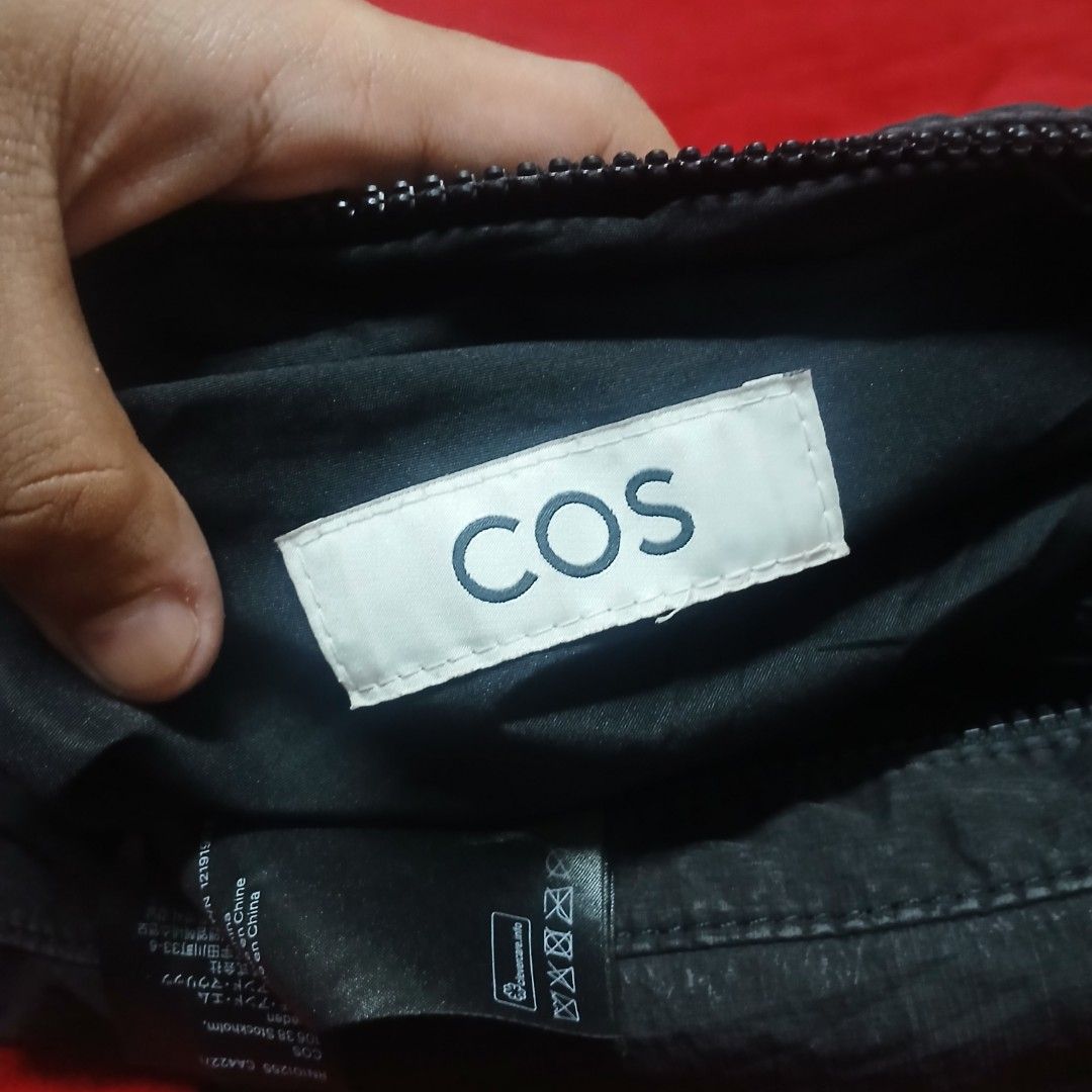 COS Crescent Crossbody Bag — Black (Category: Cross-body Bags) located in Cagayan de Oro. Submitted by susanthrifts (Listing ID 1469466127, Image 2). Description: ​Condition: Pre-owned, good condition with normal gentle edge wear along the seams. ​Details: ​Lightweight garment-washed nylon/poly fabric with a soft, slouchy crescent silhouette. ​Secure top zip closure and adjustable strap with side buckle detail. ​Interior COS label and official pr