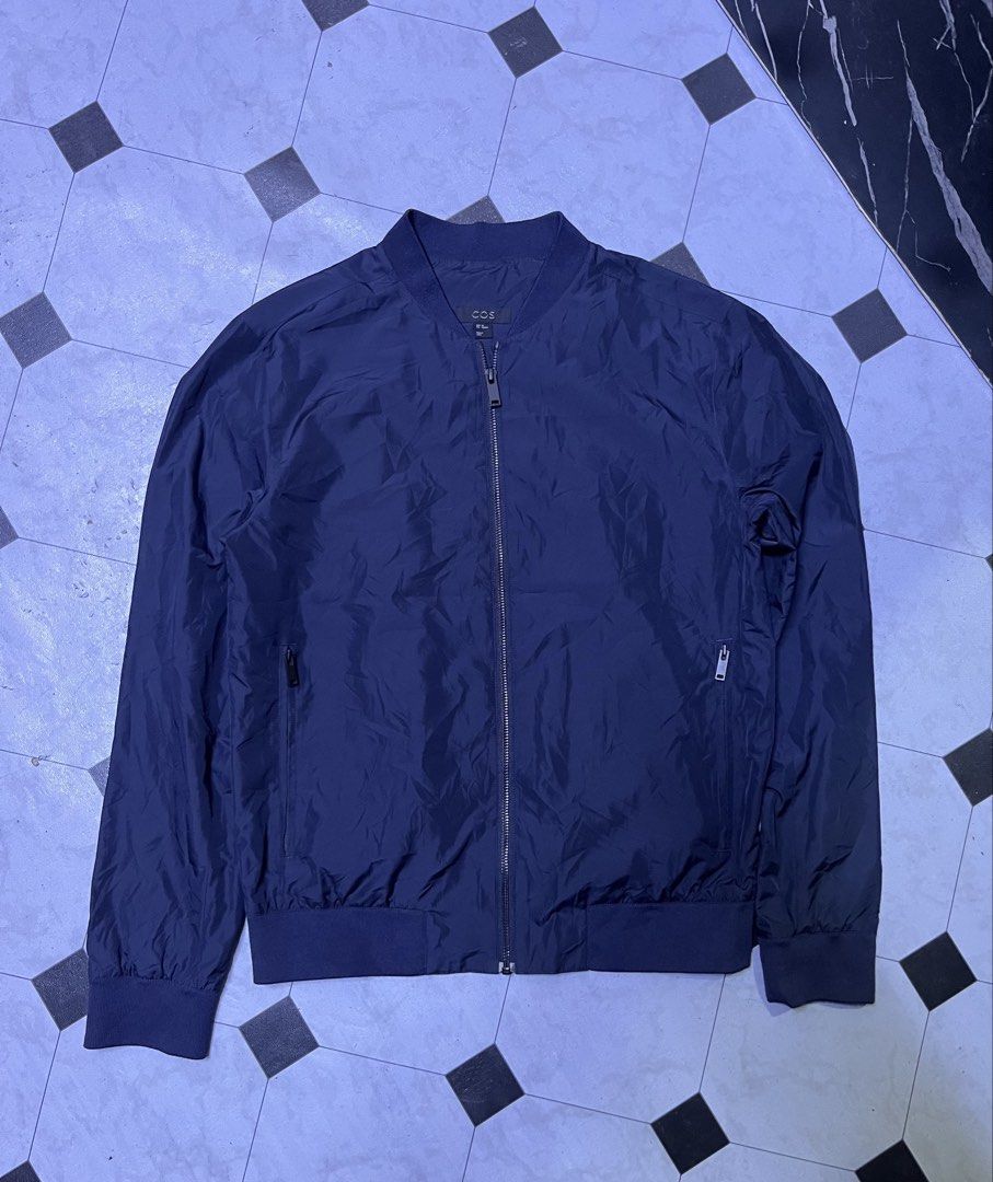 COS Navy Blue Zip Bomber Jacket Size XS (Category: Coats, Jackets and Outerwear) located in Manila. Submitted by ba_thrifted (Listing ID 1469525624, Image 2). Description: - Brand/Model: COS navy blue bomber jacket - Size: EUR XS - Design: Clean minimalist style with full front zipper - Pockets: Two secure zippered side pockets - Details: Comfortable ribbed collar, cuffs, and hem - Material: Lightweight fabric, ideal for layering in cooler weathe