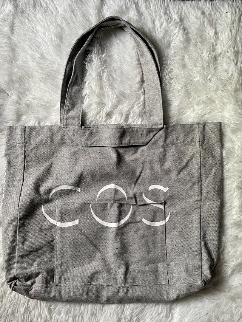 COS The Repurposed Cotton Tote Bag Grey (Category: Tote Bags) located in Tabaco. Submitted by devskie (Listing ID 1469472514, Image 1). Description: - Authentic COS The Repurposed Bag in a stylish grey speckled look - Crafted from 50% repurposed cotton and 50% regular cotton - Eco-friendly, dye-free design made to replace disposable packaging - Features the iconic white COS logo printed on the front pocket - Sturdy build ideal for everyday use - 