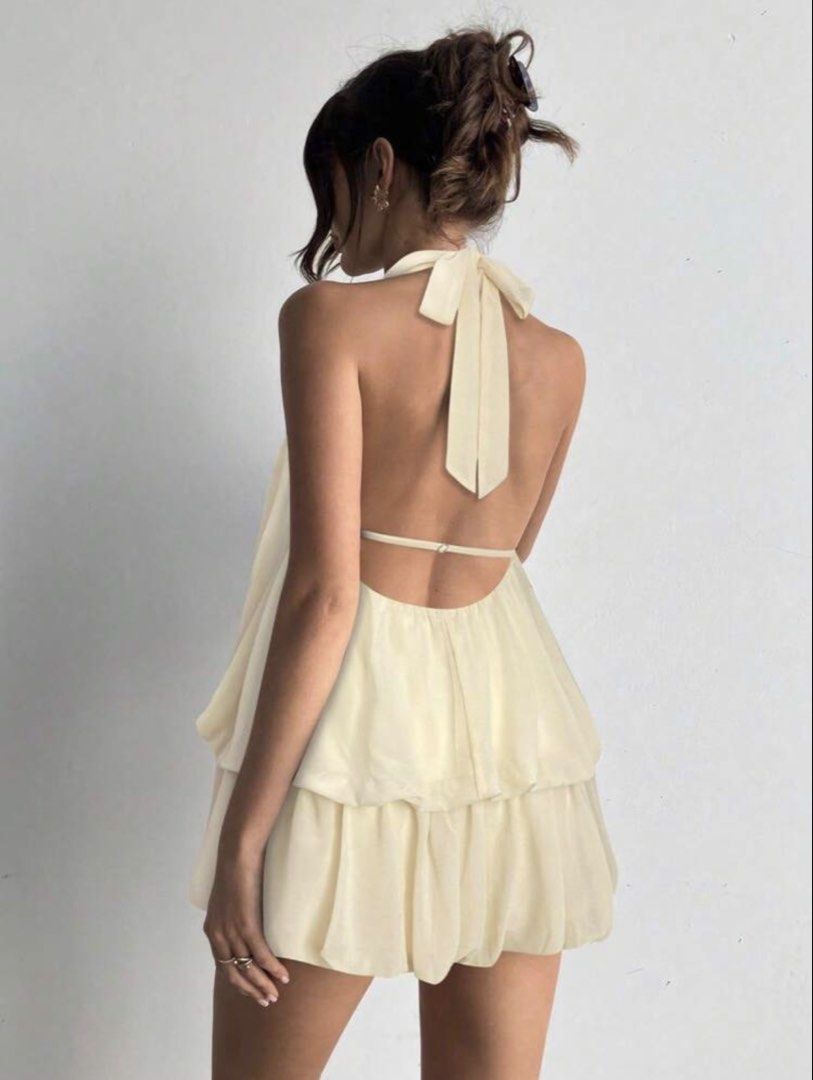 Cream Halterneck Bubble Romper Dress (Category: Dresses) located in Dasmarinas. Submitted by crtzelys (Listing ID 1469455407, Image 2). Description: - Cream halter neck mini dress - Trendy bubble hem silhouette - Open back with neck tie closure and thin back strap - Lightweight, sheer layered tiered design - Smooth sleeveless texture - Ideal for summer parties and nights out.