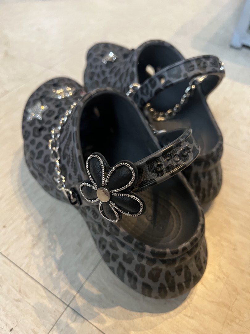 Crocs Classic Platform Leopard Print with Jibbitz Charms (Category: Slippers and slides) located in Quezon City. Submitted by Zandee (Listing ID 1469430556, Image 2). Description: - Gray and black leopard print Crocs platform clogs - Fully customized with edgy metal chains and charms - Features a black heart ribbon, sparkly star, lips, and rose charms - Super unique style that stands out instantly - Ready to wear with a totally customized look.