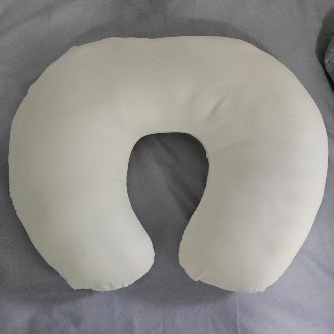 C-shaped nursing pillow baby feeding support (Category: Breastfeeding & Bottle Feeding) located in Muntinlupa City. Submitted by erikaelejido (Listing ID 1469462302, Image 2). Description: - Color: Off-white - Design: C-shaped for optimal support - Fabric: Soft, comfortable cover - Condition: Clean and ready to use - Features: Compact size, perfect for couch or bed use during feeding and lounging.