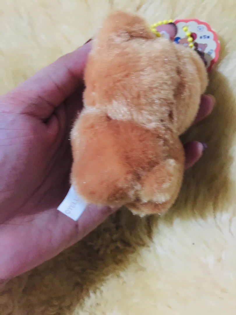 Cute brown bear plush keychain with red plaid bow (Category: Plushies & Soft Toys) located in Baguio. Submitted by izza_thrifty (Listing ID 1469567691, Image 2). Description: - Adorable fluffy brown bear plush with a red and black plaid bow tie - Includes a convenient yellow ball chain for bags or keys - Features a sweet white muzzle and tiny open-mouth detail - Authentic YELL brand with original paper tag still attached - Compact size, perfect f