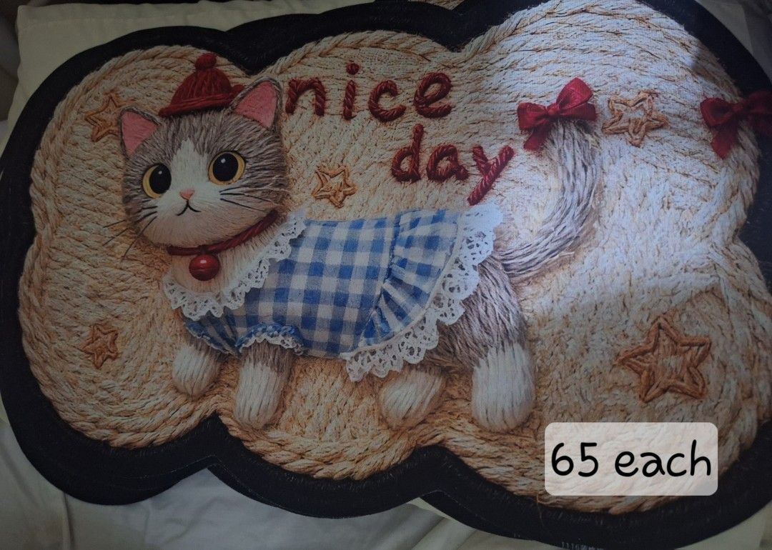 Cute Cat Nice Day Design Floor Mat Rug (Category: Carpets, Mats & Flooring) located in Manila. Submitted by noblegem04 (Listing ID 1469564014, Image 1). Description: - Adorable cat-themed floor mat featuring a sweet 'Nice Day' text - Charming design with a cat wearing a blue checkered dress, red hat, and collar - Stylish textured woven look accented with cute star decorations - Versatile placement: ideal for doorways, bedrooms, or living spaces -