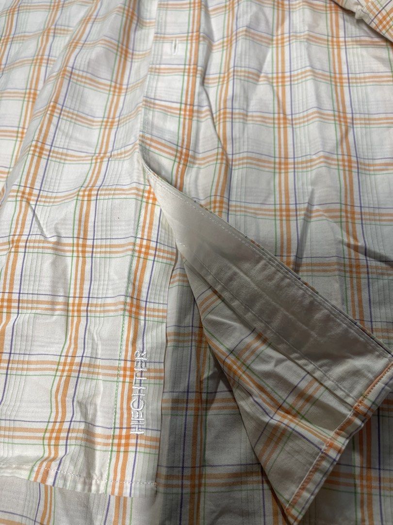 Daniel Hechter Long Sleeve Plaid Button-Down Shirt (Category: Formal Shirts) located in Mandaluyong City. Submitted by coolmeybab (Listing ID 1469459003, Image 2). Description: - Brand: Daniel Hechter - Style: Long sleeve button-down shirt - Color/Pattern: White base with orange, purple, and green plaid - Features: Classic collar, front button closure, button cuffs, single chest pocket - Details: Embroidered logo near bottom hem, pleated back yok