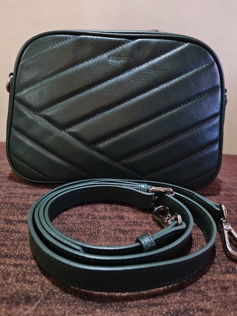 Esquire Dark Green Quilted Crossbody Camera Bag (Category: Cross-body Bags) located in Bulacan. Submitted by marichuman79038 (Listing ID 1469434536, Image 3). Description: - Color: Dark green with silver-toned hardware - Material: Pebbled leather texture with diagonal quilted pattern - Closure: Secure top zipper - Strap: Includes matching detachable and adjustable strap - Style: Compact, clean shape, and minimalist design ideal for daily essentia