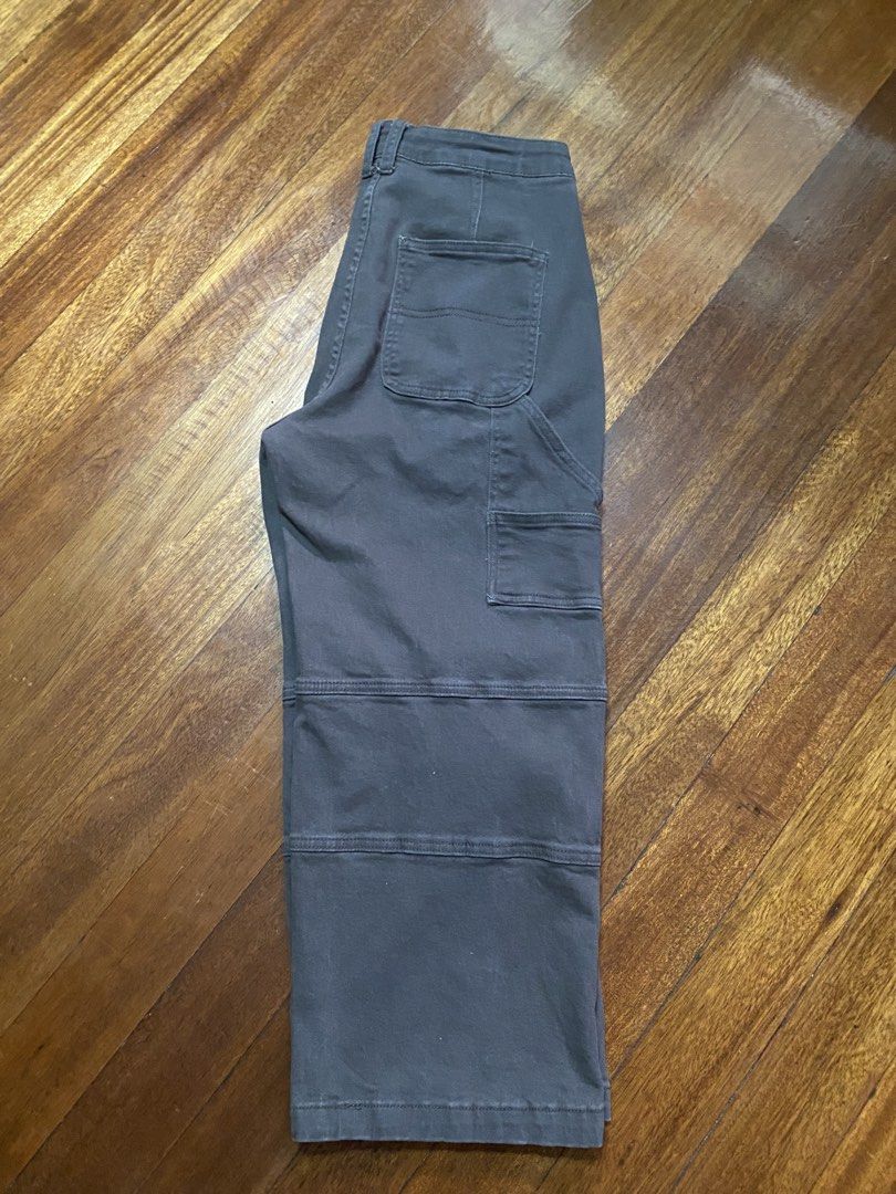 Dark Grey Layered Cargo Pants Size 31 (Category: Jeans) located in Baguio. Submitted by cs_studio248 (Listing ID 1469463648, Image 3). Description: - Color: Dark grey / charcoal wash - Size: Tagged size 31 - Material: 98% cotton, 2% spandex for a slight stretch - Fit: Relaxed straight leg cut - Details: Layered knee panels, utility pockets, button and zip fly closure - Condition: Clean hem and intact back pockets.