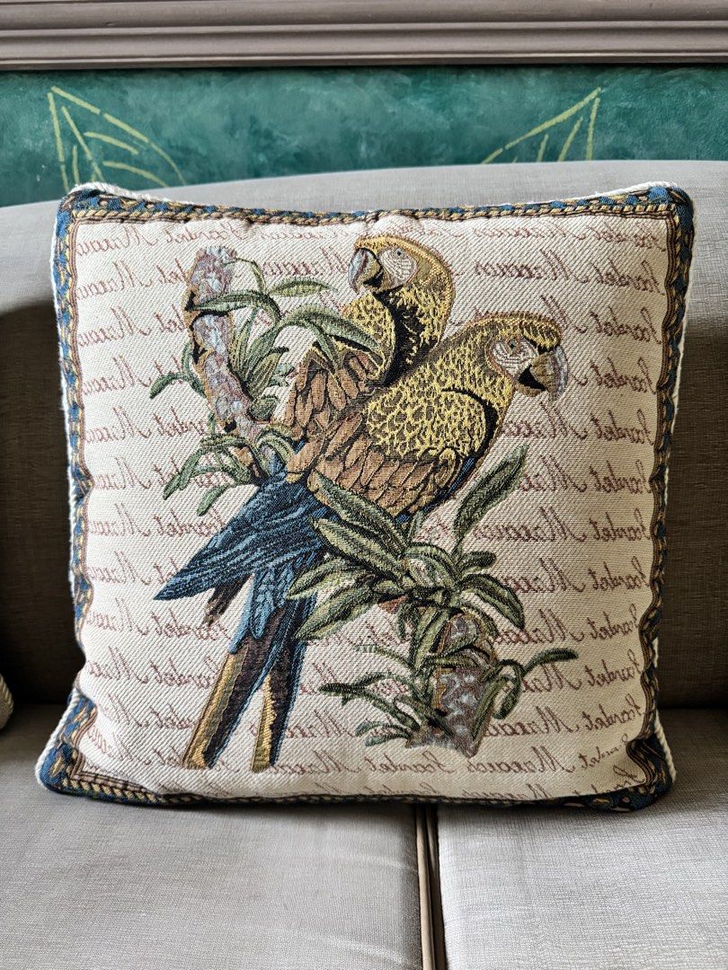 Decorative Tapestry Throw Pillows – Floral Pair & Parrot Design (Category: Cushions & Throws) located in Makati City. Submitted by maria.1024 (Listing ID 1469455212, Image 2). Description: Beautiful set of three decorative tapestry throw pillows featuring richly detailed woven designs. * Two matching floral pillows with colorful botanical motifs, vintage-style lettering and cream backgrounds. * One coordinating parrot pillow featuring two parrots