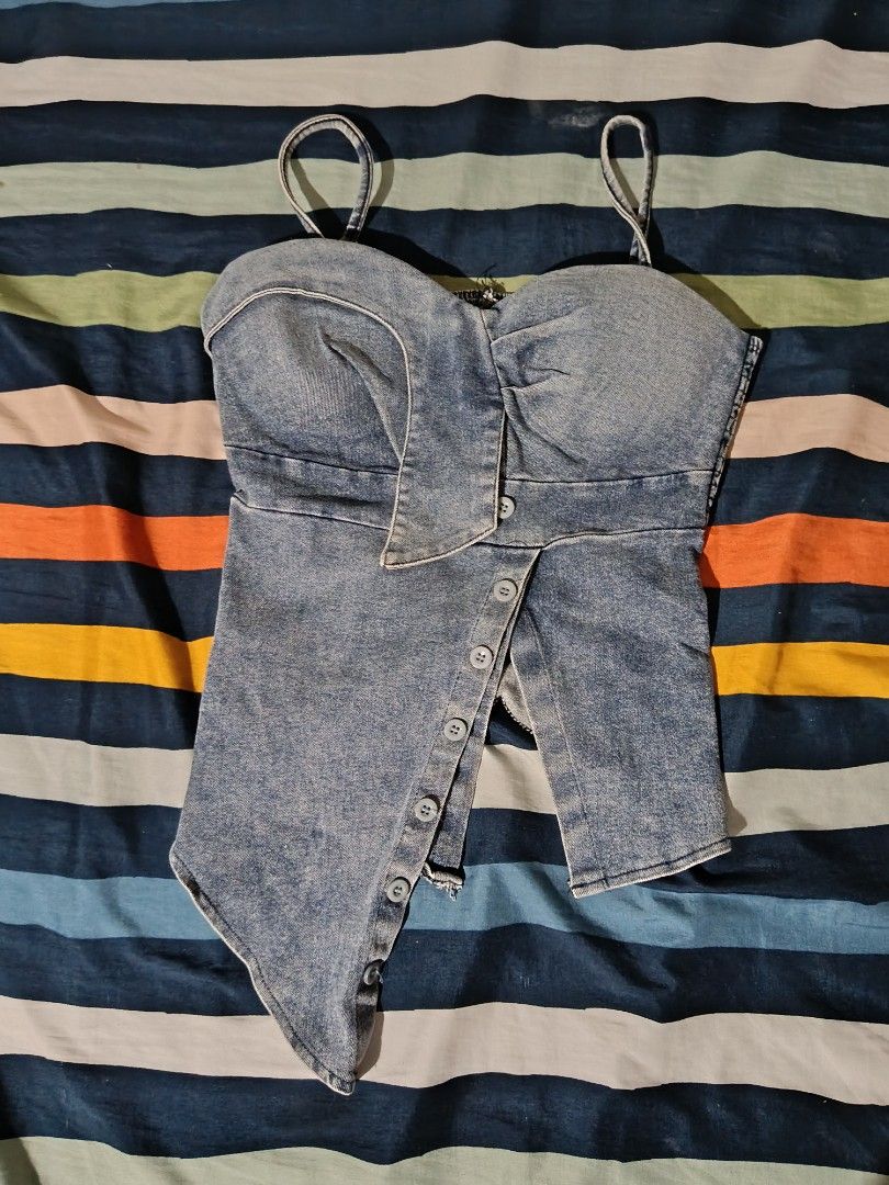 Denim Top with Asymmetrical Hem and Buttons (Category: Sleeveless) located in Pasay City. Submitted by angeldollx (Listing ID 1469486172, Image 1). Description: 💮 light wash asymmetrical denim bustier top 💮 padded, adjustable straps, zip lock 💮 XXS - XS 💮 NO FLAWS! .