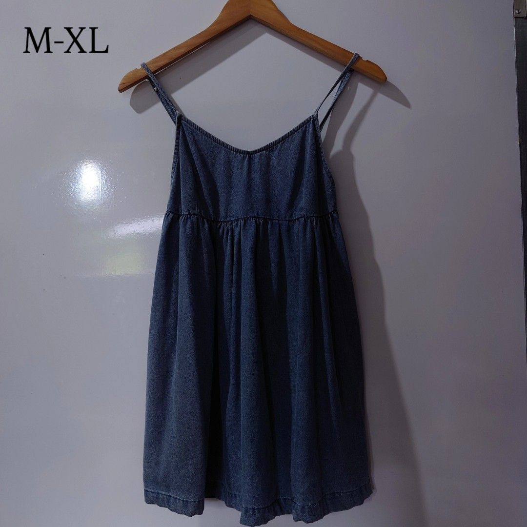 Denim Spaghetti Strap Dress Blue M-XL (Category: Dresses) located in Diffun. Submitted by declutteredbyJill (Listing ID 1469570241, Image 1). Description: - Style: Blue denim cami dress with soft wash finish - Design: V-neck, thin double straps, and gathered empire waist for a flowy, loose fit - Size: Fits Medium to Extra Large (Semi-Oversized) - Comfort: Lightweight and easy to throw on - Perfect for: Casual everyday wear and warm sunny days.