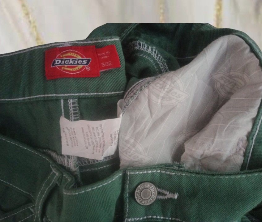Dickies Green Cargo Shorts Size 15/32 (Category: Shorts) located in Naga. Submitted by abouttocome (Listing ID 1469405976, Image 3). Description: - Brand: Dickies - Color: Green denim with contrast white stitching - Size: 15/32 - Material: 100% durable cotton - Features: Multiple side and back pockets, utility loop, iconic red logo patch - Closure: Button closure with zip fly - Condition: Excellent everyday wear.