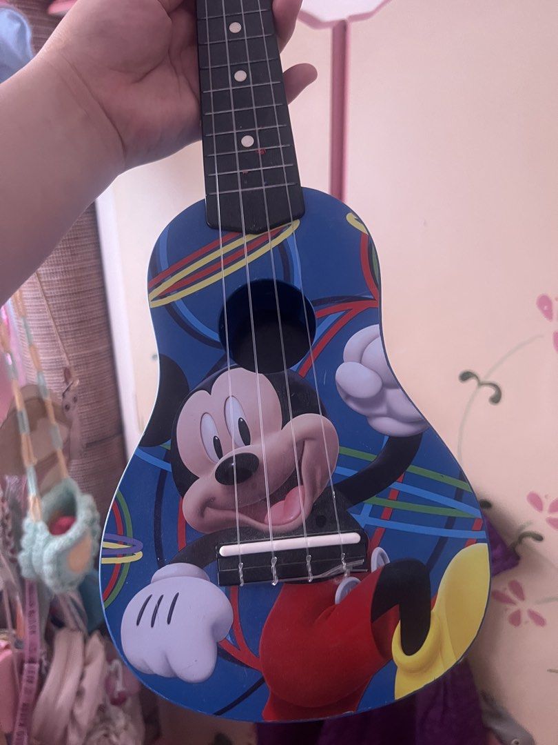 Disney Mickey Mouse Blue Kids Ukulele (Category: Musical Instruments) located in Cebu City. Submitted by shofaholicz (Listing ID 1469456000, Image 3). Description: - Fun blue Mickey Mouse ukulele designed for kids - Features a cute Mickey graphic on the front - Unique custom Mickey head tuning pegs at the headstock - Standard 4 nylon strings setup that is safe for little hands - Great starter toy instrument for young Disney fans.