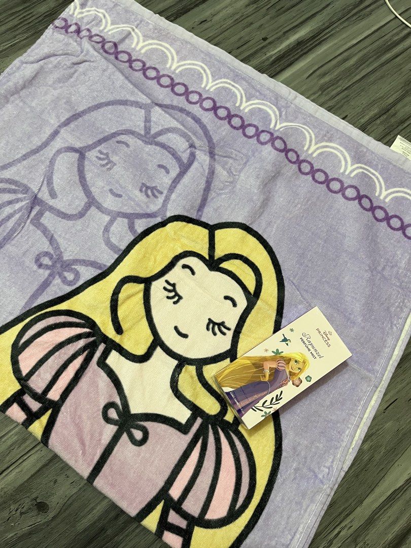 Disney Princesa Rapunzel Beach Towel (Category: Bedding & Towels) located in Manila. Submitted by kaye012222 (Listing ID 1469398393, Image 3). Description: - Official Disney Princess Rapunzel design in lovely purple and yellow - Material: 100% soft, high-quality cotton - Features vibrant printed graphics on the front with a plain white terry loop backing - Brand new with official Disney merchandise tag attached - Perfect for beach trips, pool day