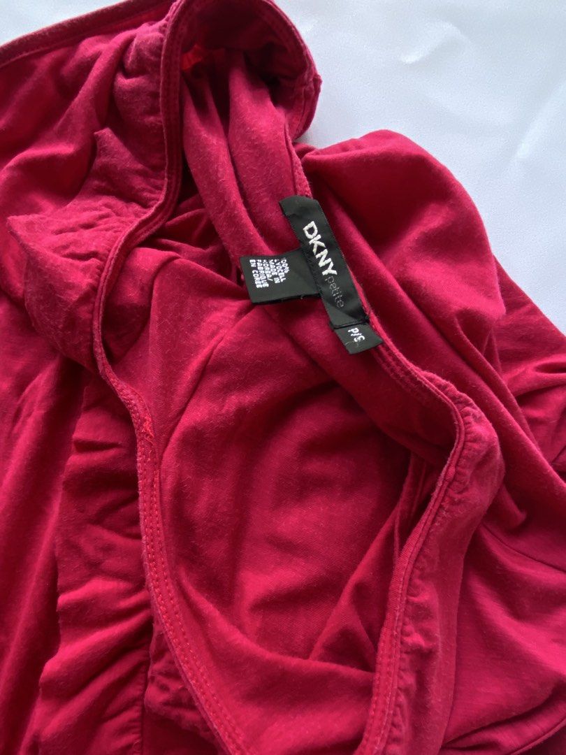 DKNY Petite Ruffled Tank Top (Category: Sleeveless) located in Cauayan City . Submitted by alt_olshop4 (Listing ID 1469539003, Image 3). Description: - Brand: DKNY - Color: Bright pink - Size: Petite Small (P/S) - Material: 100% lyocell (ultra-soft feel) - Design: Sleeveless, deep V-neck with ruffle trim - Origin: Made in Korea - Condition: Clean overall with minor fabric wear near the label and a small hole near the underarm seam (as shown in ph