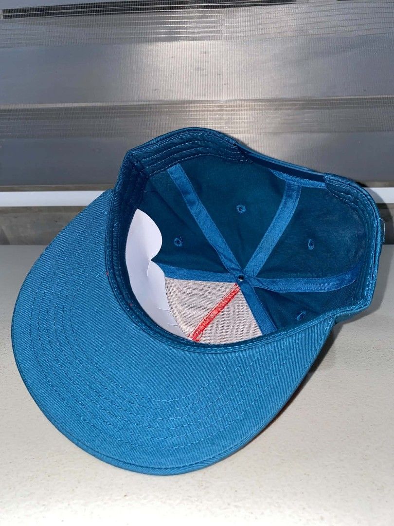 Dogfish Head x Grateful Dead Snapback Hat (Category: Caps & Hats) located in Baler. Submitted by mariokush193815 (Listing ID 1469453230, Image 3). Description: - Official Dogfish Head and Grateful Dead collaboration hat - Vibrant red front panel with contrasting dark blue brim and back panels - Eye-catching circular embroidered patch featuring the iconic skull, lightning bolt, and shark graphic - Adjustable plastic snapback closure for a customiz