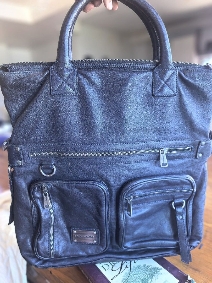 Dolce & Gabbana leather tote bag (Category: Luxury Bags & Wallets) located in Cagayan de Oro. Submitted by tommygurl1218 (Listing ID 1469460137, Image 1). Description: - Authentic Dolce & Gabbana black leather tote bag - Dual top handles with reinforced stitching for extra durability Handle only but with sling slot - Multiple exterior zippered front compartments for easy organization - Signature metal hardware brand plaque on the lower front - Da