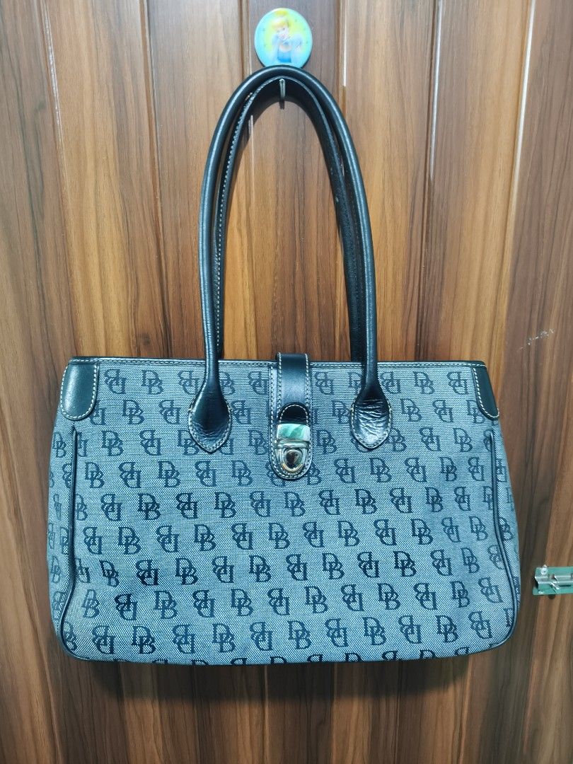 Dooney & Bourke Monogram Tote Bag Dark Green (Category: Luxury Bags & Wallets) located in Davao. Submitted by navil01 (Listing ID 1469527163, Image 1). Description: - Brand: Dooney & Bourke - Material: Dark green monogram canvas with black leather trim - Hardware: Silver-tone with front clasp closure - Interior: Pink fabric lining with zipped middle compartment, zipper pocket, and slip pockets - Condition: Clean inside and out, very spacious for 
