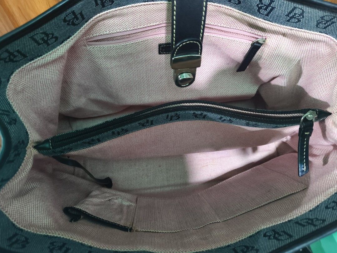Dooney & Bourke Monogram Tote Bag Dark Green (Category: Luxury Bags & Wallets) located in Davao. Submitted by navil01 (Listing ID 1469527163, Image 3). Description: - Brand: Dooney & Bourke - Material: Dark green monogram canvas with black leather trim - Hardware: Silver-tone with front clasp closure - Interior: Pink fabric lining with zipped middle compartment, zipper pocket, and slip pockets - Condition: Clean inside and out, very spacious for 