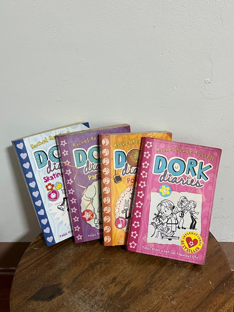 Dork Diaries Book Bundle (Category: Children's Books) located in Cabuyao City. Submitted by rdtrmt (Listing ID 1469412885, Image 2). Description: - Set of 4 Dork Diaries books by Rachel Renée Russell - Includes popular titles like Party Time, Skating Sensation, and Pop Star - Fun and engaging reads for kids, teens, and young at hearts - Condition: Pre-loved paperbacks with minor shelf wear on edges - Inside pages are clean and well-maintained but