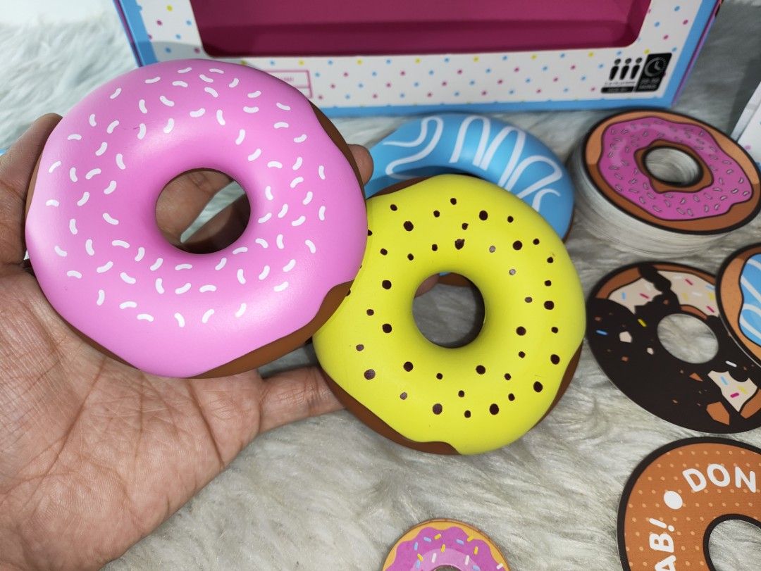 Dough Nab The Game by G Games (Category: Board Games & Puzzles) located in Cavite. Submitted by tinetaclesss (Listing ID 1469497891, Image 2). Description: - Game: Fun family doughnut matching and grabbing board game - Players: 3 to 6 players, ages 8 and up - Playtime: Fast-paced 20 to 30 minutes per round - Inclusions: 3 squishy toy doughnuts, 60 doughnut cards, winner's hat, turn tracker, and rule book complete .
